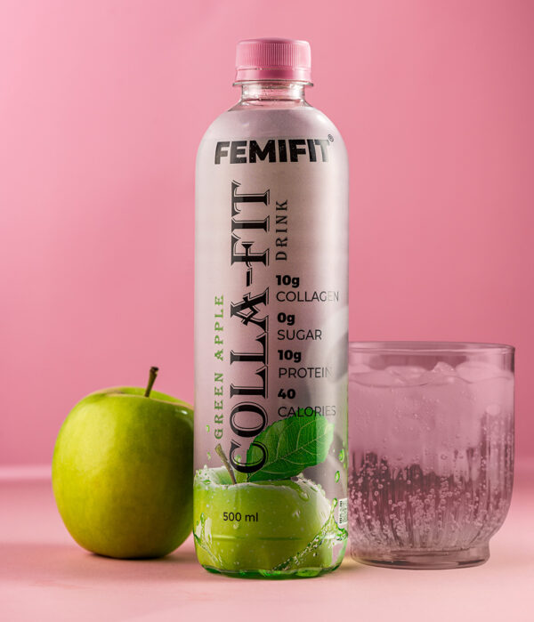 Green apple collagen bottle next to a glass full of ice and a green apple.