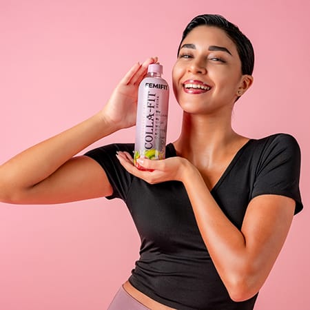 a lady holding a bottle of collagen (Colla-Fit)