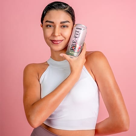 a lady holding a can of Pre-Fit drink.